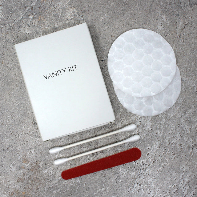 White box vanity kit showing contents - cotton buds, cotton pads and emery board