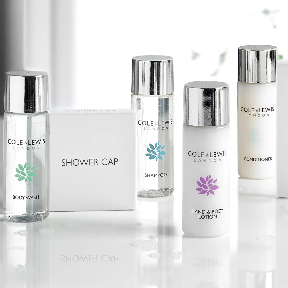 Cole & Lewis London skincare products including body wash, shampoo, shower cap, hand & body lotion, and conditioner in a lifestyle setting