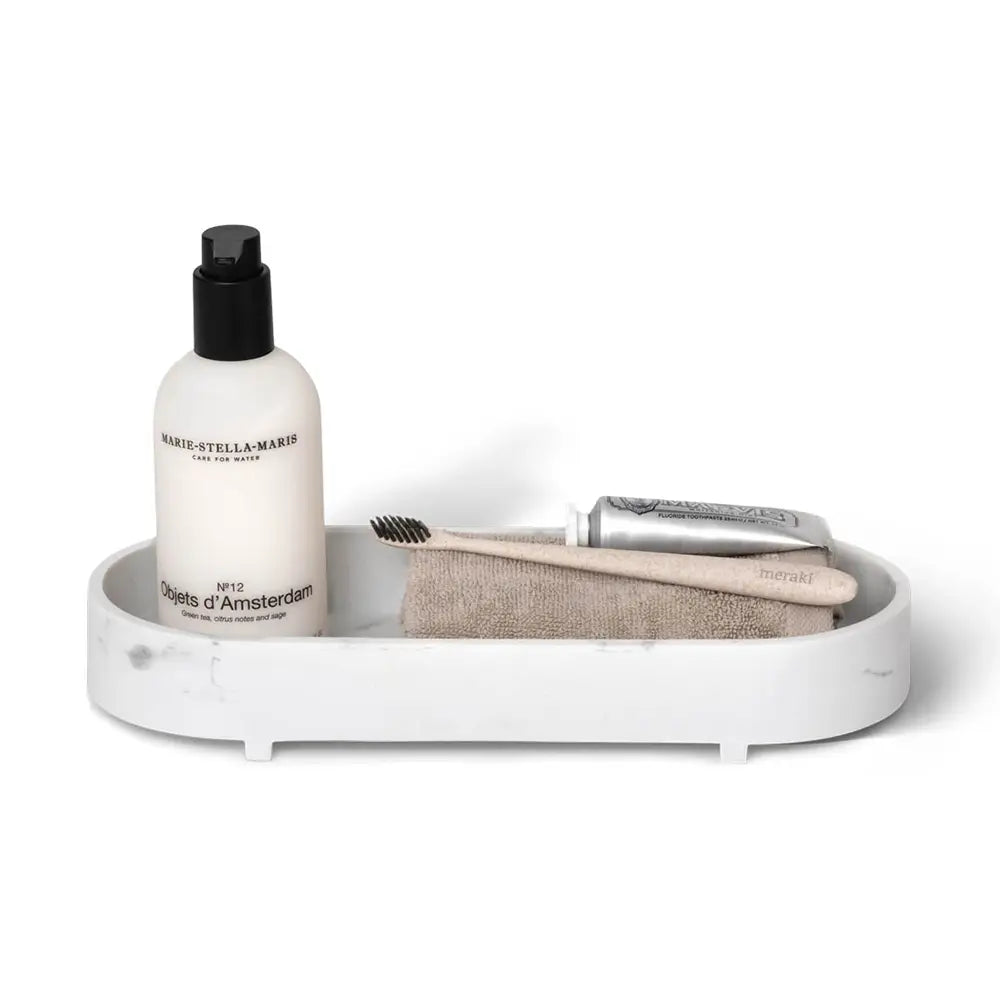 White tray with skincare products on a white background