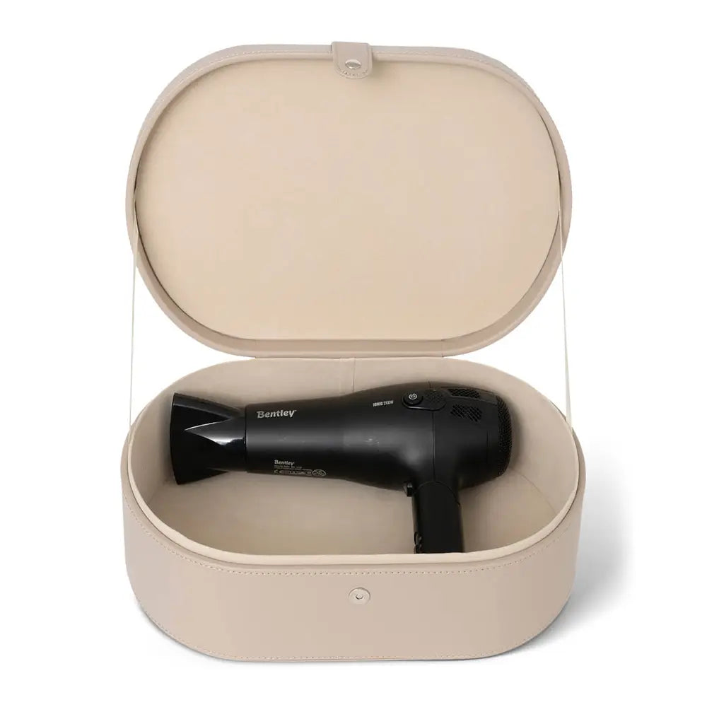 Black hair dryer in a beige storage case on a white background
