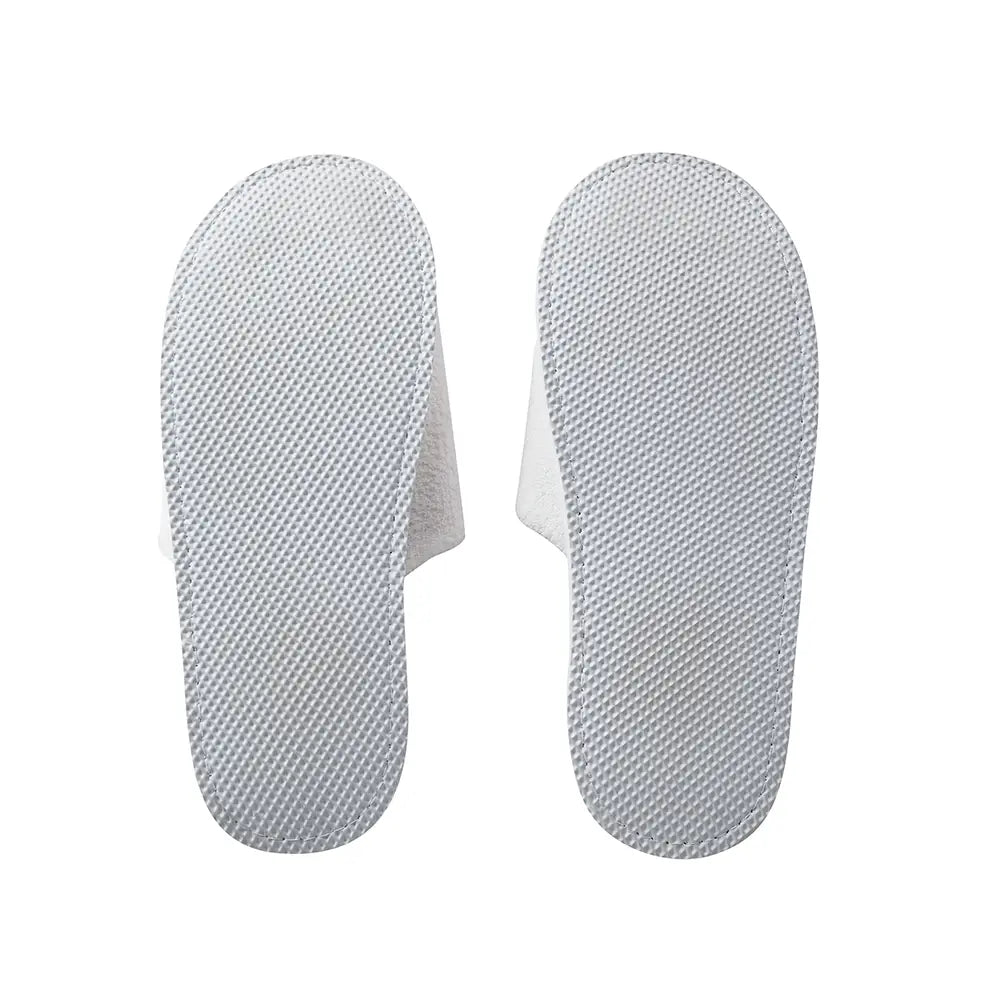 Pair of white slippers' soles on a white background