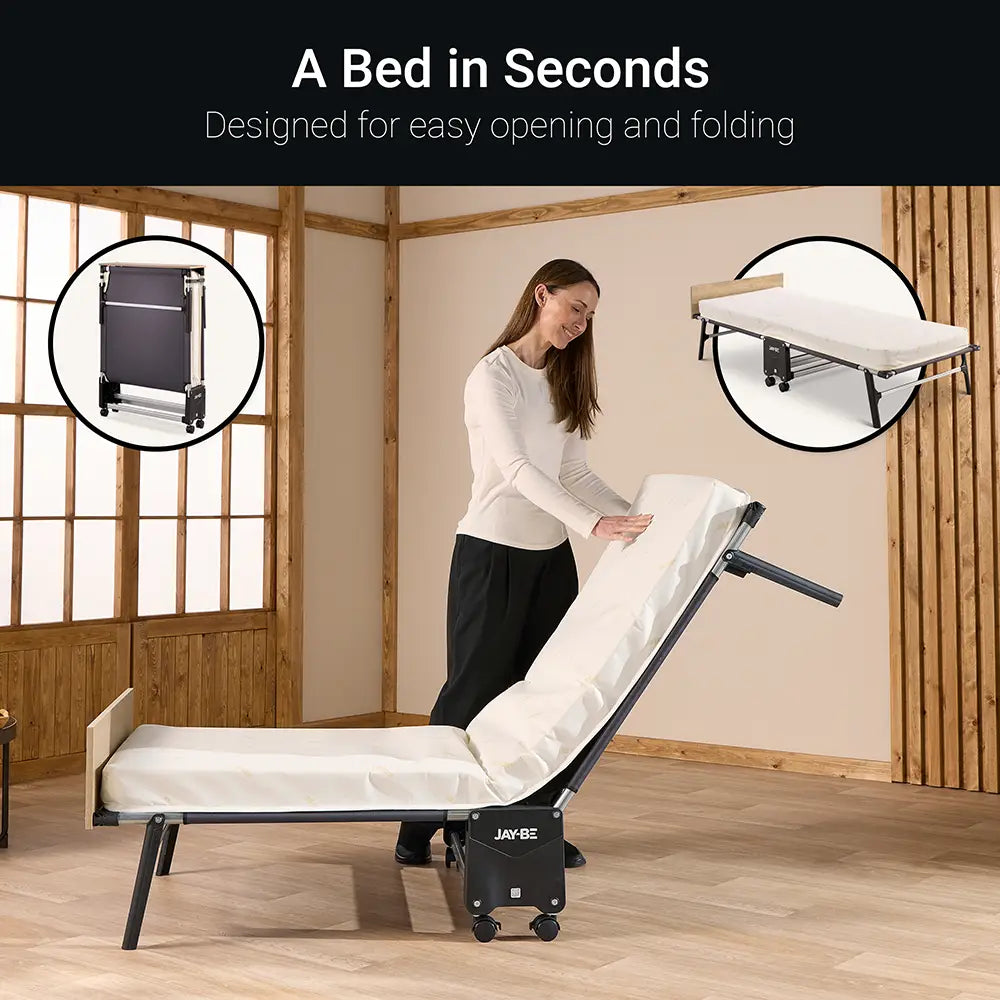 Woman setting up a portable bed in a room with wooden walls and floor.
