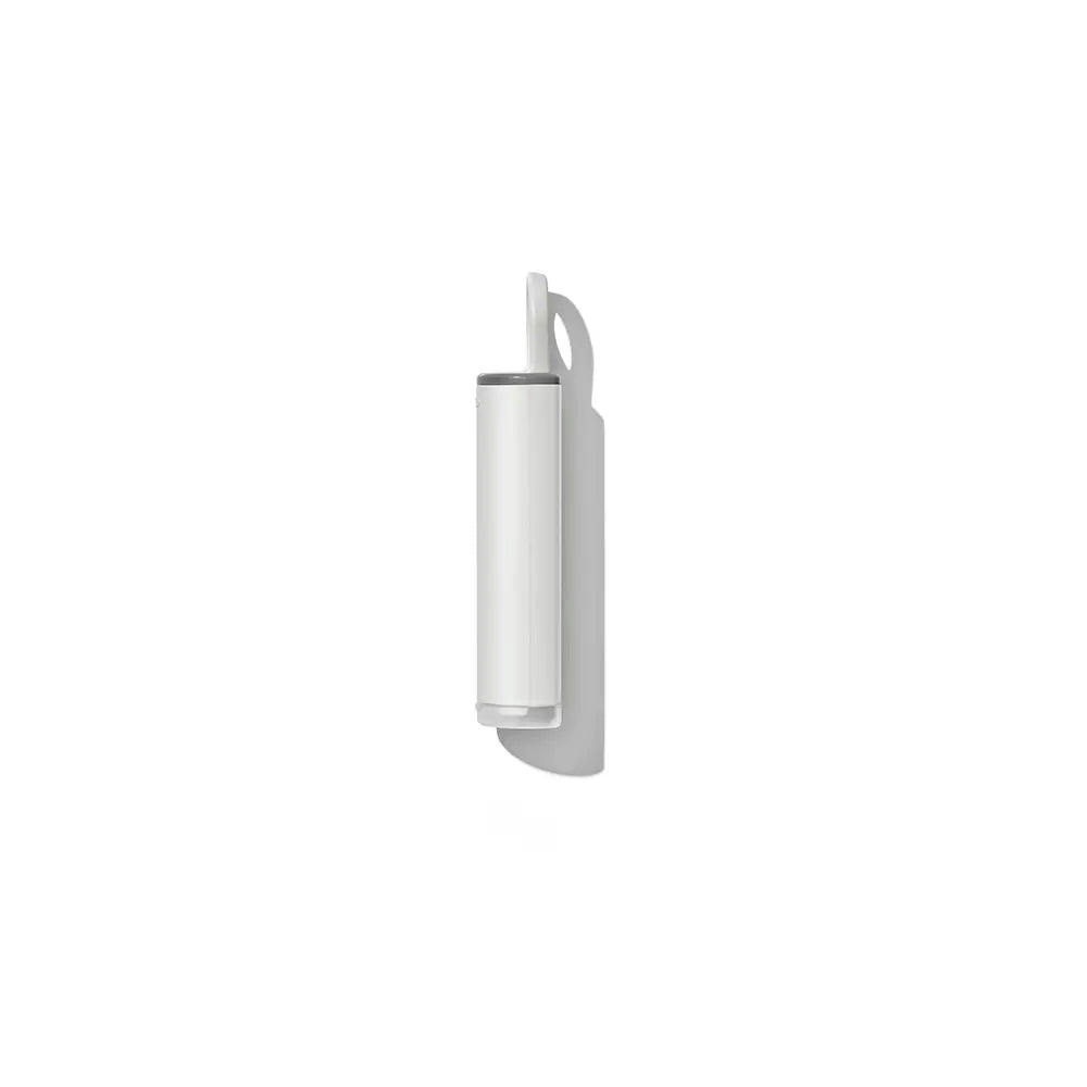 Oxo Lint Brush side profile while closed, with a small loop at the top, shown against a solid white background with a soft shadow.