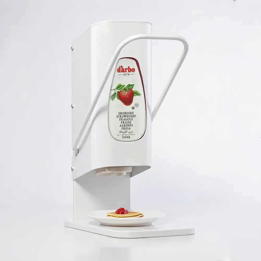 Darbo jam dispenser with lever, shown dispensing onto a pancake