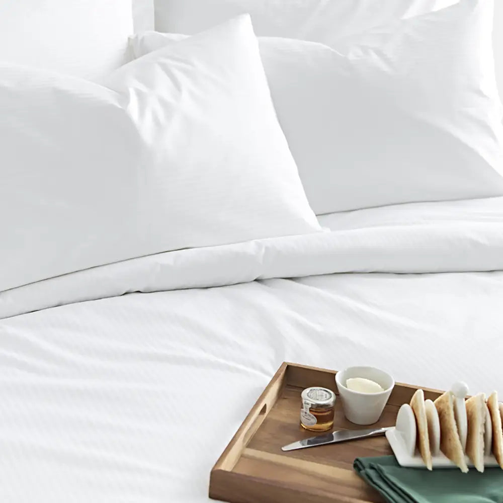 Luxury Cotton Micro Stripe 300 Thread Count Duvet Cover with a wooden tray holding food on a white background
