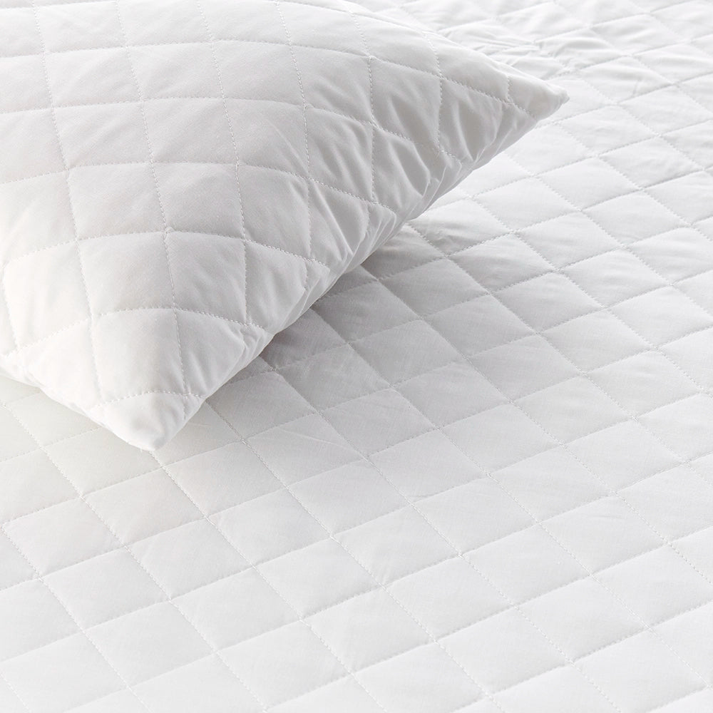 Close up of quilted pillow protector showing detailed diamond stitching