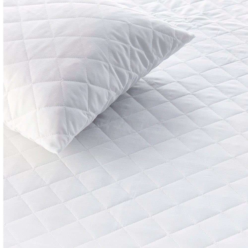 Quilted mattress protector showing diamond stitching and matching pillow protector