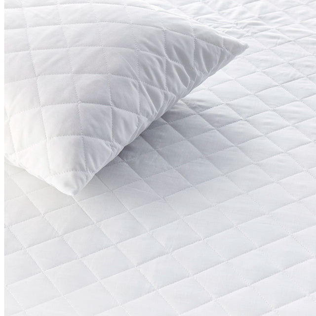 Quilted mattress protector showing diamond stitching and matching pillow protector
