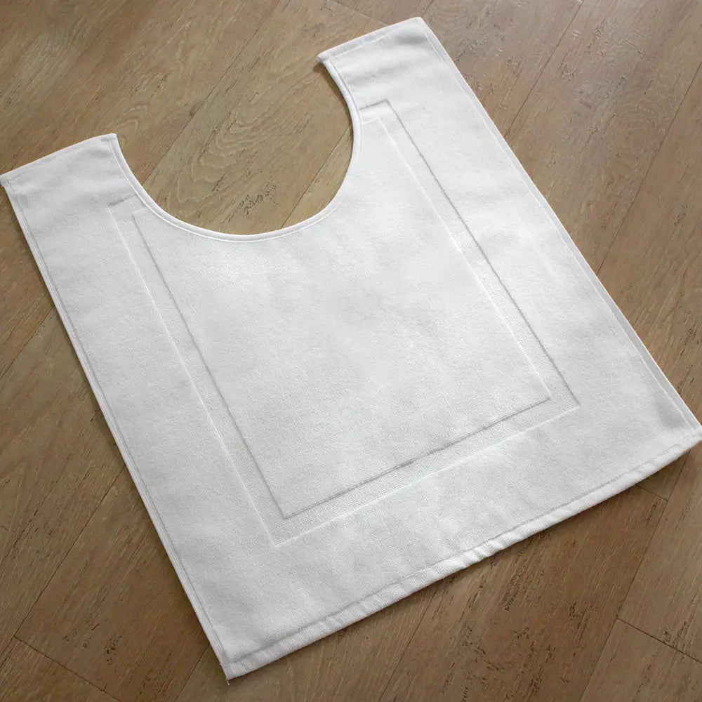 A white luxury 900gsm cotton pedestal mat designed to fit around the base of a toilet.