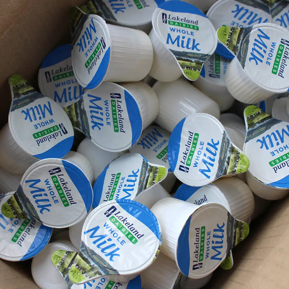An open box of Lakeland Dairies Whole Milk Pots with blue and white lids