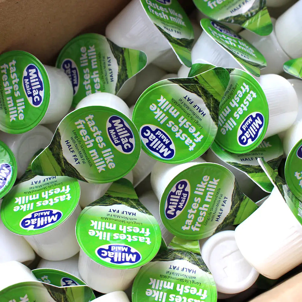 An open box of Millac Mail Half Fat Milk Pots with Green Lids