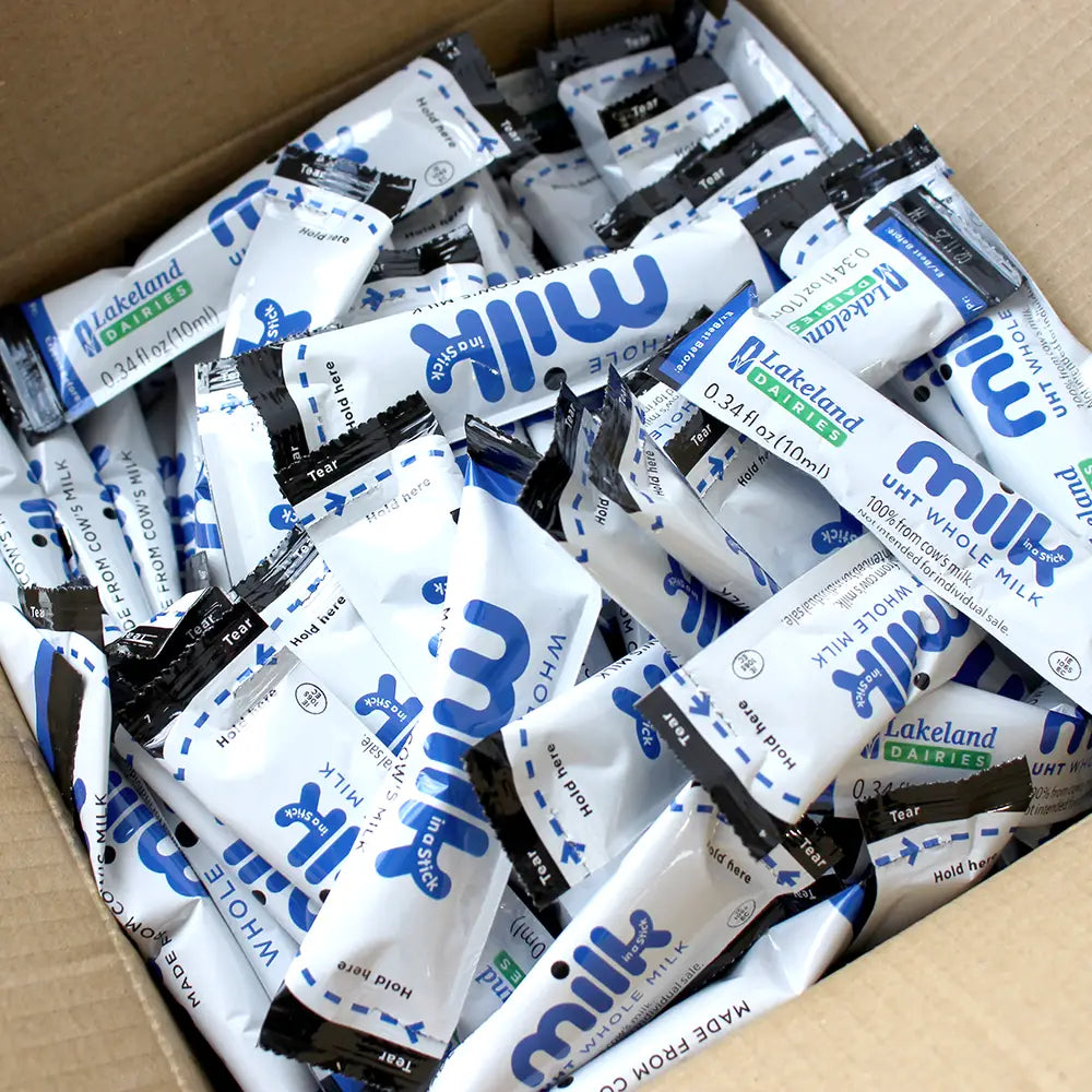 An open box of Lakeland Dairies Whole UHT Milk in a Stick with blue and white packaging