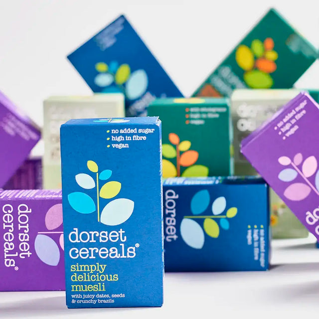 Dorset Cereals Simply Delicious Muesli Portion Packs with other cereal boxes in the background