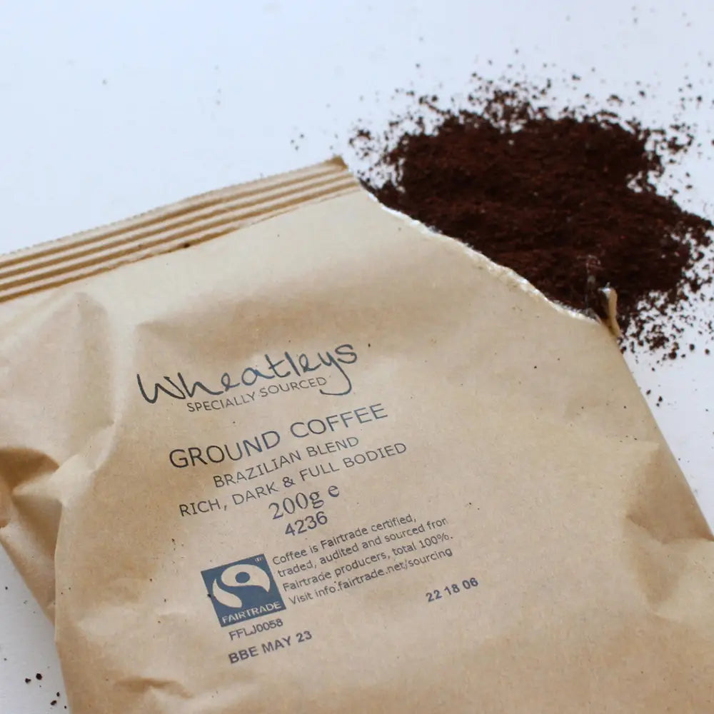 Wheatleys ground coffee package with coffee grounds on a white background