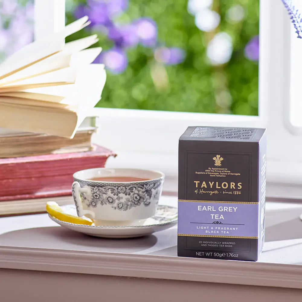 Taylors of Harrogate Earl Grey tea box with a teacup and lemon on a windowsill.