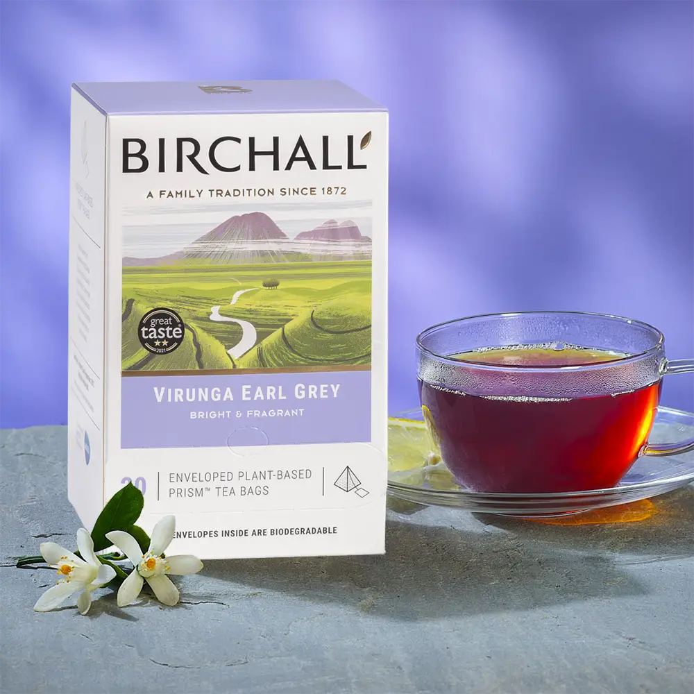Box of 20 Virunga Earl Grey Tea Bags from Birchall next to a glass cup of freshly brewed tea