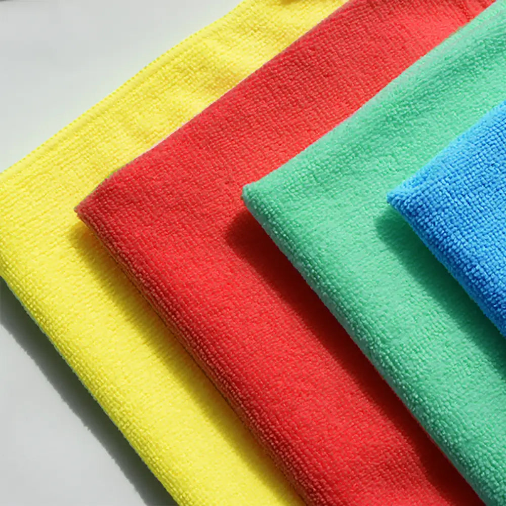 Four colorful microfiber cloths in yellow, red, green, and blue.