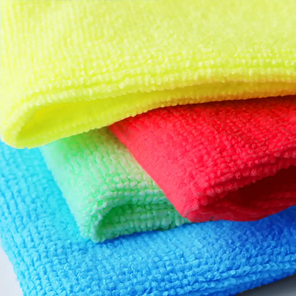 Stack of colorful microfiber cloths in yellow, red, green, and blue.