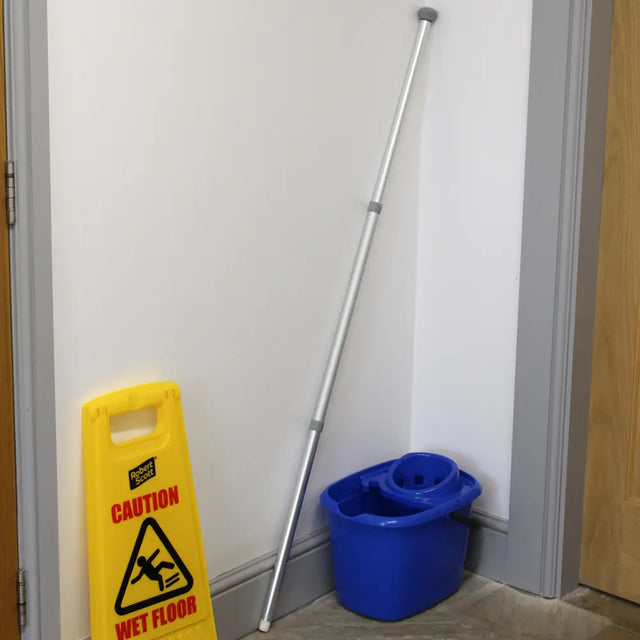 Extra Long Mop & Broom Handle against a wall in lifestyle setting