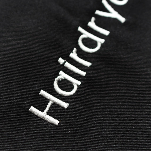 Close up of embroidery on the front of the hairdryer bag