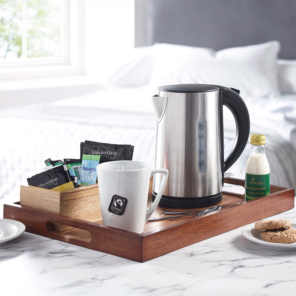 Acacia wooden room tray in a room setting with kettle, mug, selection of beverage sachets and bottle of milk
