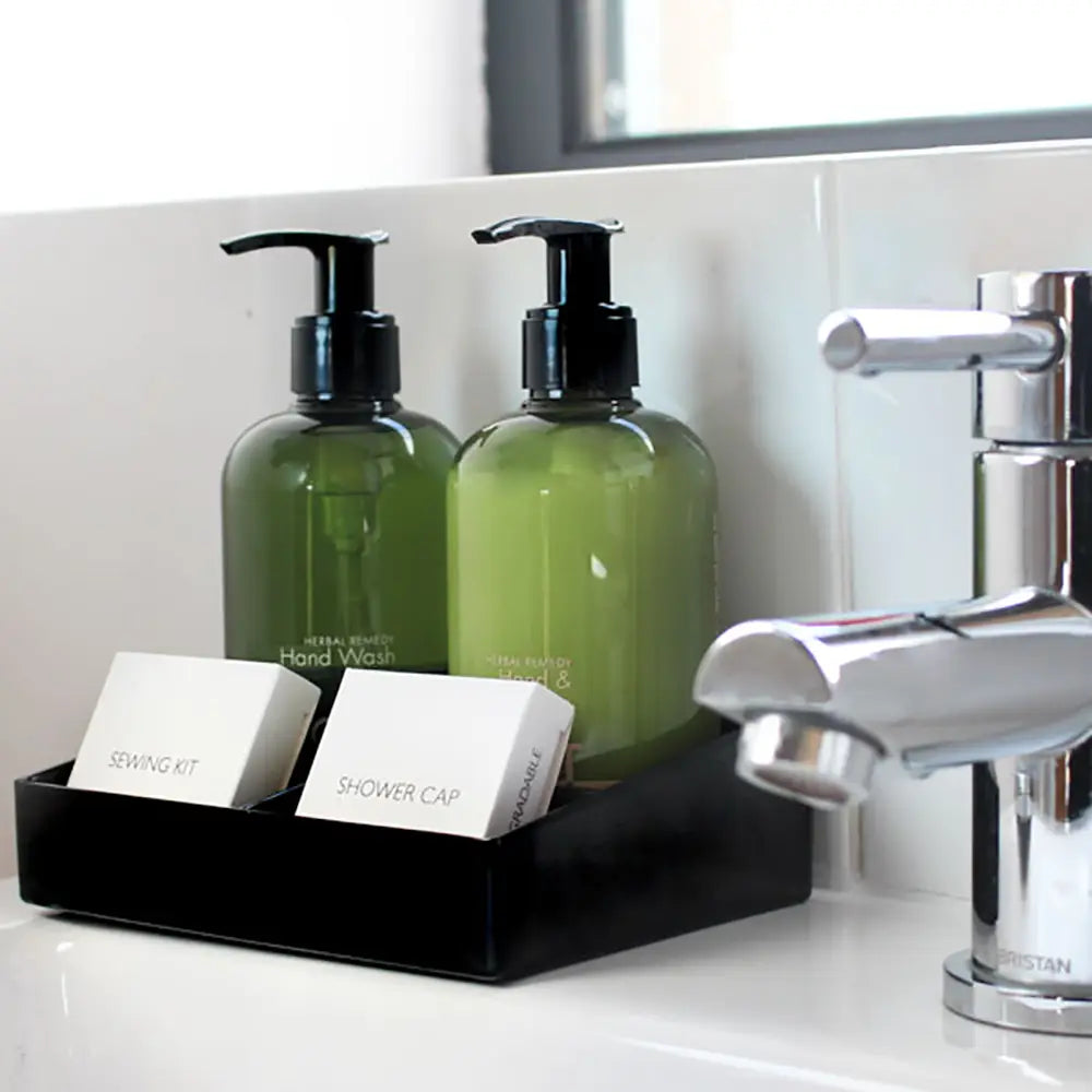 Bathroom sink with Small black Melamine Display Tray with toiletries including bottles and a soap bar