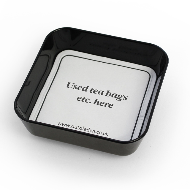 small black tray displaying coaster for used tea bags