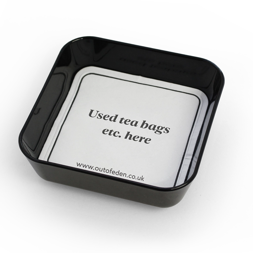 small black tray displaying coaster for used tea bags