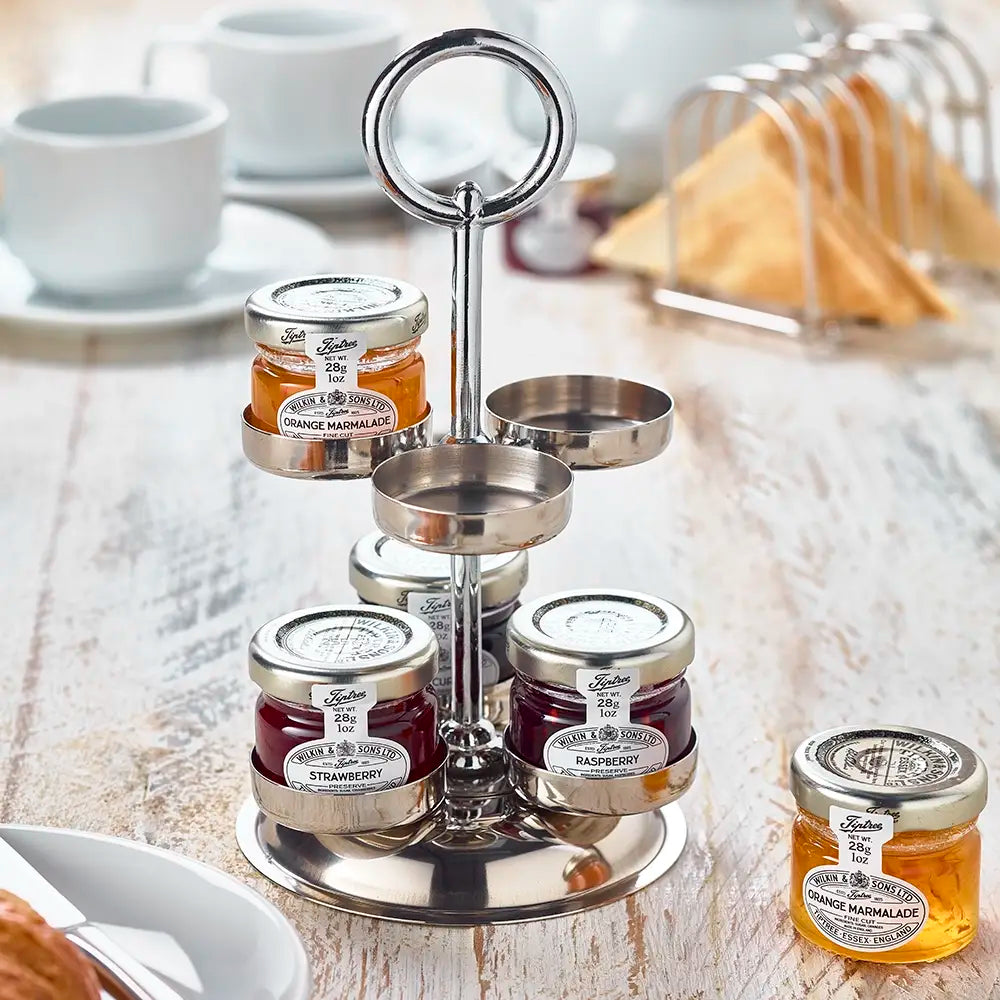 Metal jam stand with jars of jam, orange marmalade, raspberry jam on a wooden table