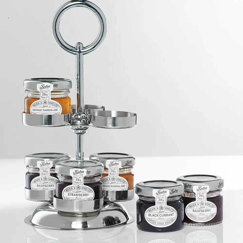 Silver three-tiered stand with jars of jam on a white background