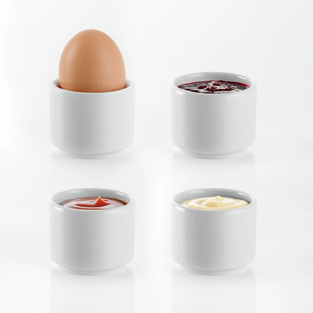 Egg cups with boiled egg and with selection of sauces