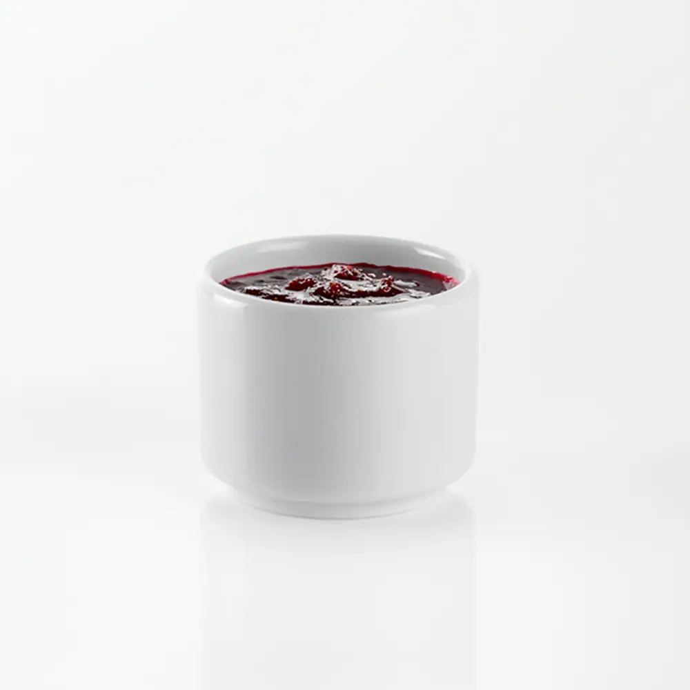 White ceramic cup with Jam inside on a white ground