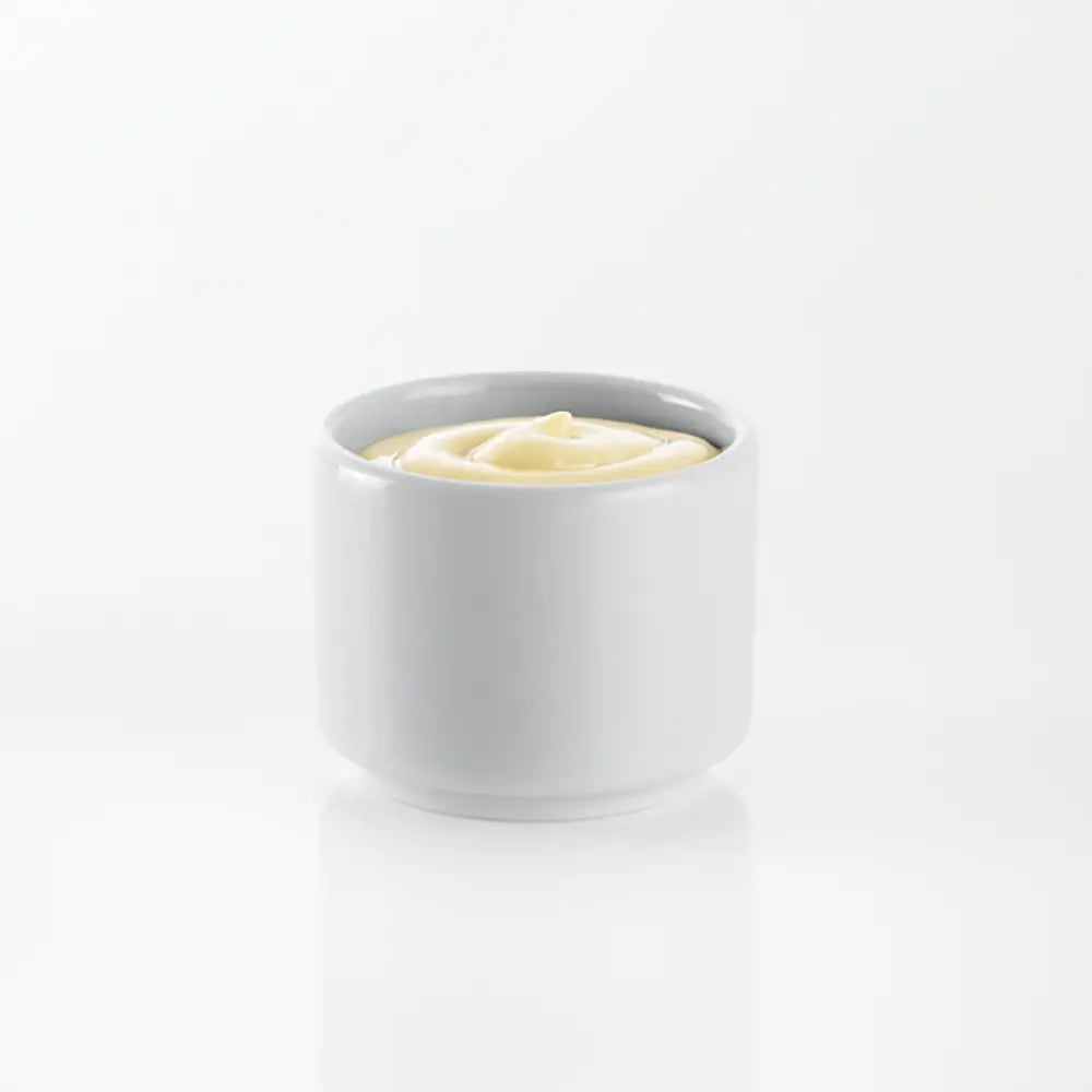 White bowl with mayonnaise on a white background