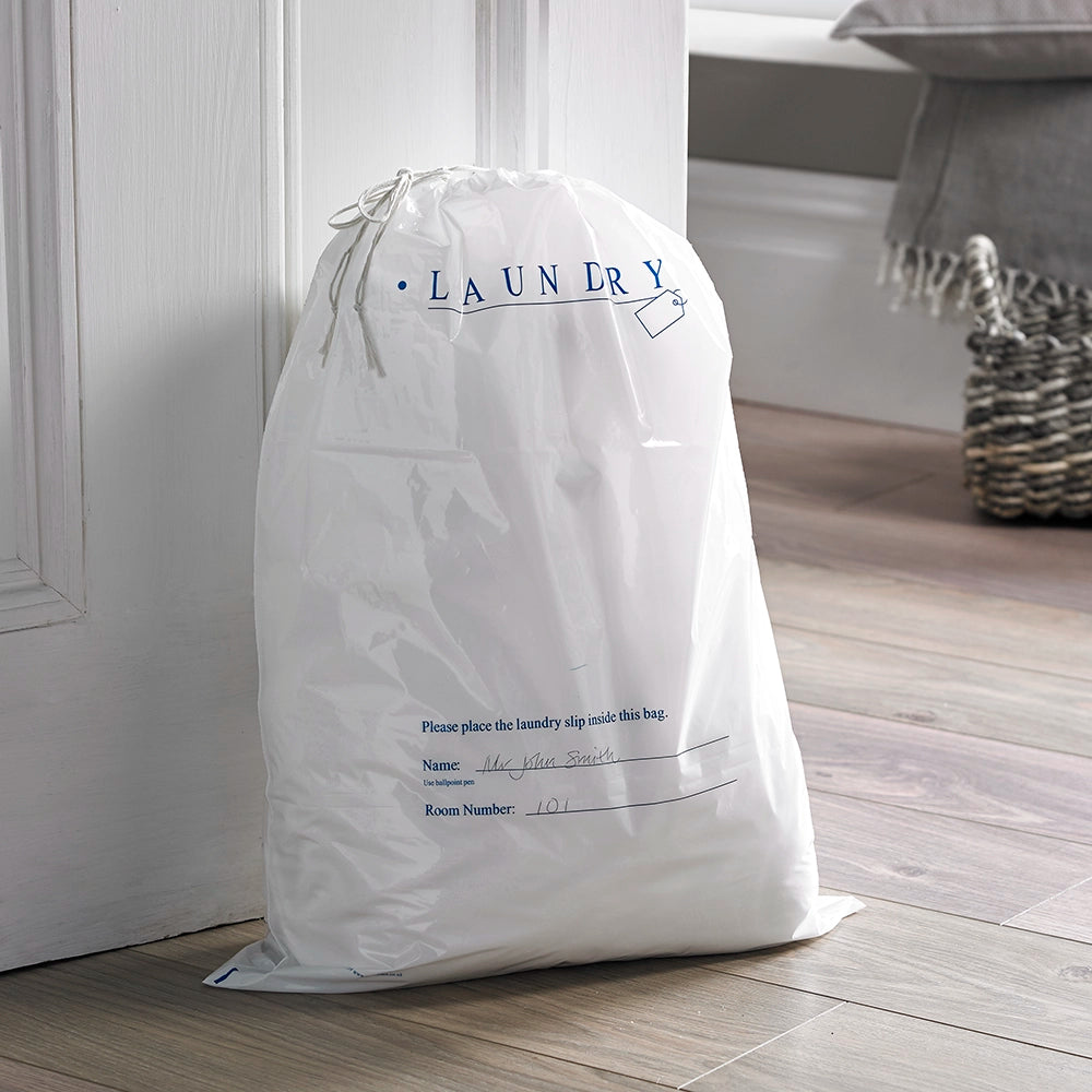 Plastic Laundry bag propped against a door showing where name and room number can be written