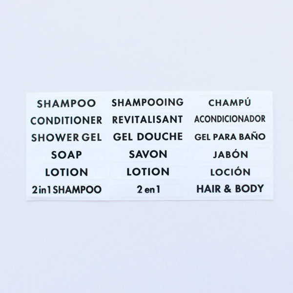 A sheet of labels with various labels for shampoo, conditioner, shower gel, soap, lotion, and 2in1 shampoo products, printed in English, French, and Spanish.