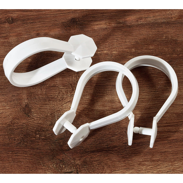 3 White plastic rings used for hanging a shower curtain
