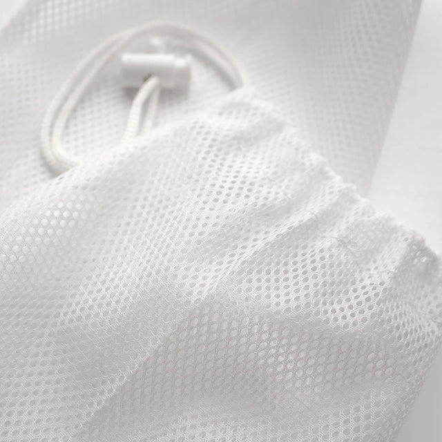Close up detail of mesh storage bag fabric and spring toggle closure