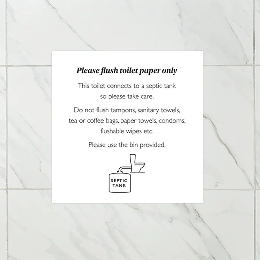 Septic tank notice - Instructions for using a septic tank toilet on a tiled wall.