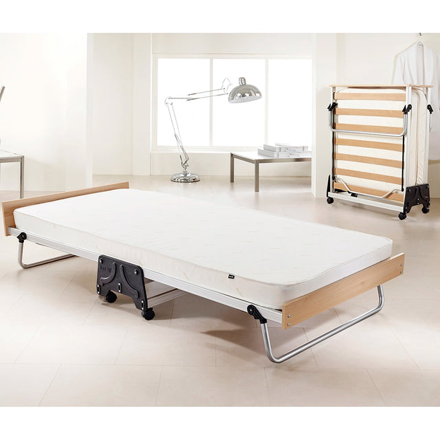 Jay be J-Bed in open position in room setting, with a folded bed in the background