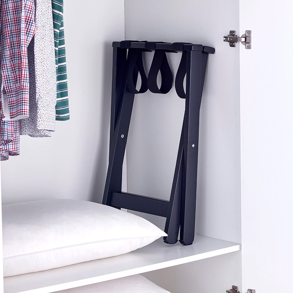 Luggage stand black, folded and stored in a wardrobe
