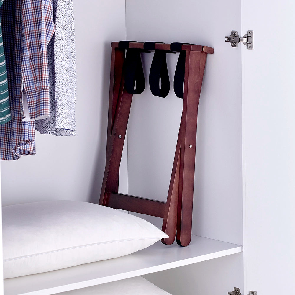 Dark wood luggage stand folded and stored in a wardrobe