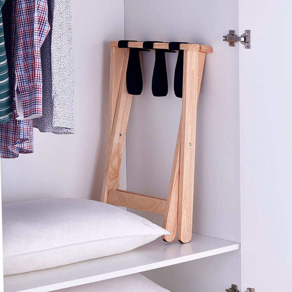 Light wood luggage stand folded and stored in a wardrobe