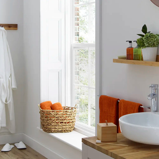 Bamboo container in lifestyle setting - Bathroom interior with a window, sink, and featuring items from Cole and Lewis lemongrass and bergamot range on a shelf.