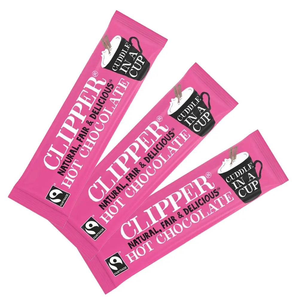 Three pink packets of Clipper hot chocolate on a white background