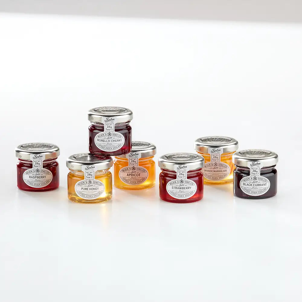 Assorted jars of jam on a white background