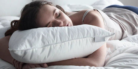 Woman sleeping soundly on a hotel pillow from Out of Eden