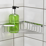 Green bottle of Cole & Lewis body wash on a metal corner shower caddy against a tiled wall.