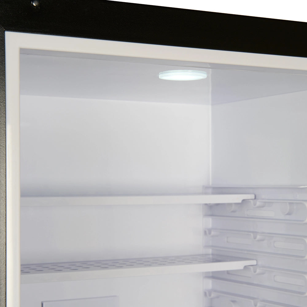 Empty refrigerator interior with shelves and a light on.