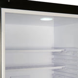 Empty refrigerator interior with shelves and a light on.