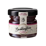 Jar of Boddington's Raspberry Conserve with a black lid on a white background